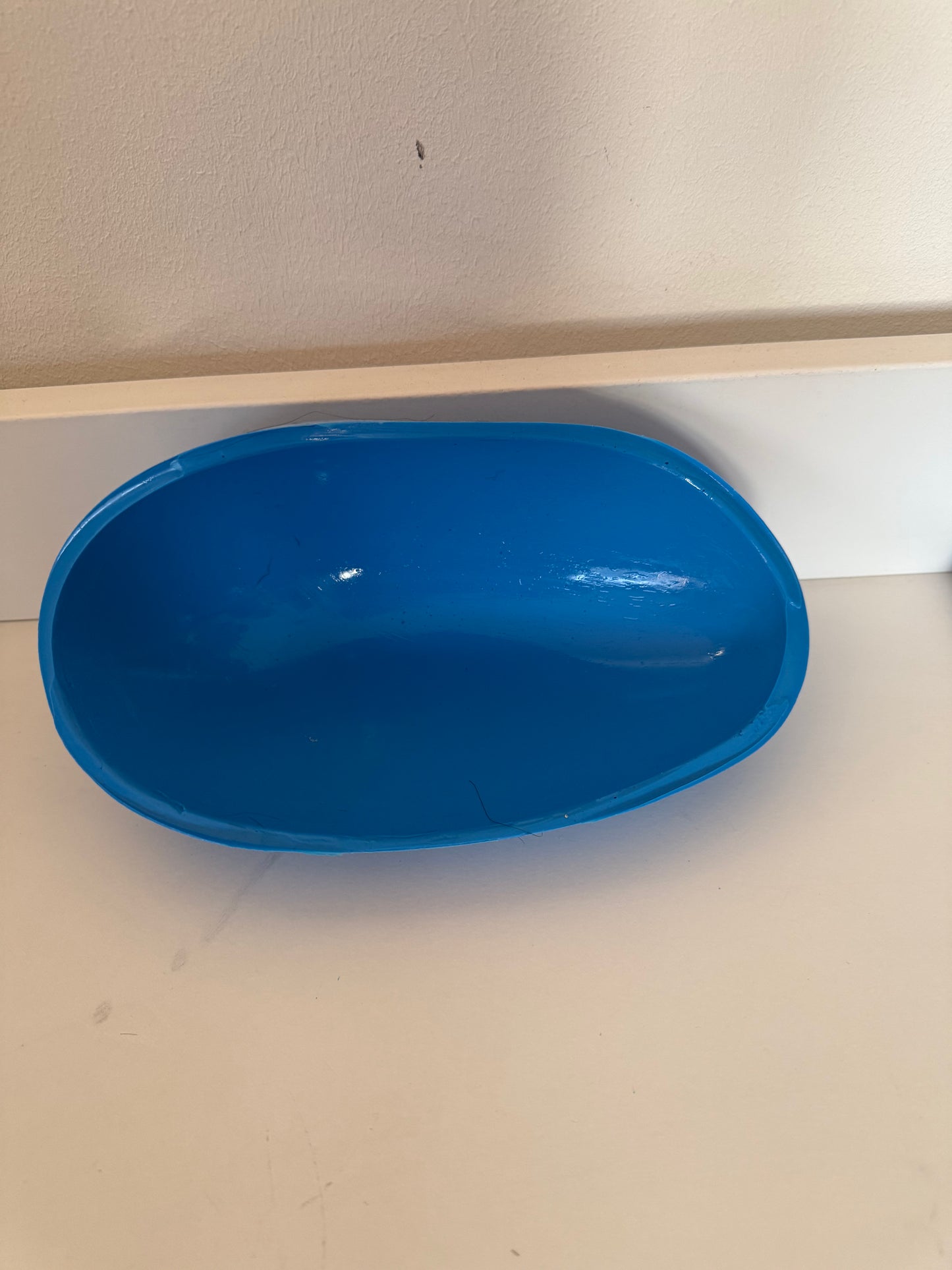 Support en caoutchouc incurvé pour l'injection de mèches de cheveux sur une micro-peau en vue de la fabrication de prothèses capillaires.